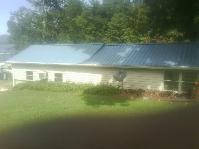 Blue metal roof running the length of a single story home in Garden City